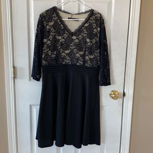 NWT black knee length dress. Lace overlay top of dress. Lace sleeves v-neck